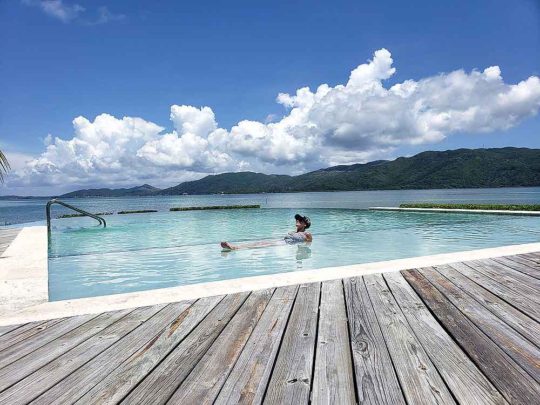 woman relaxing in Clark's infinity pool